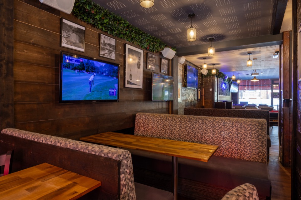 Booths and big screen in the bar
